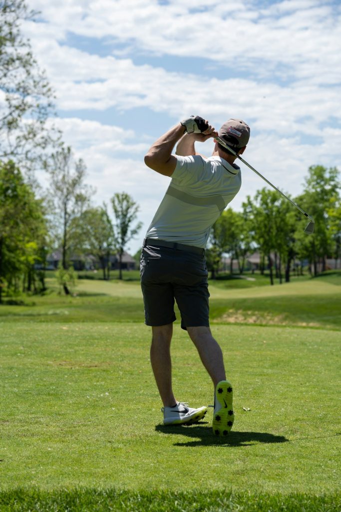man-in-white-t-shirt-and-black-shorts-holding-golf-club-kaz6uu54zje
